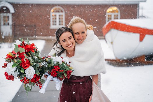 bride and made of honor in snow
